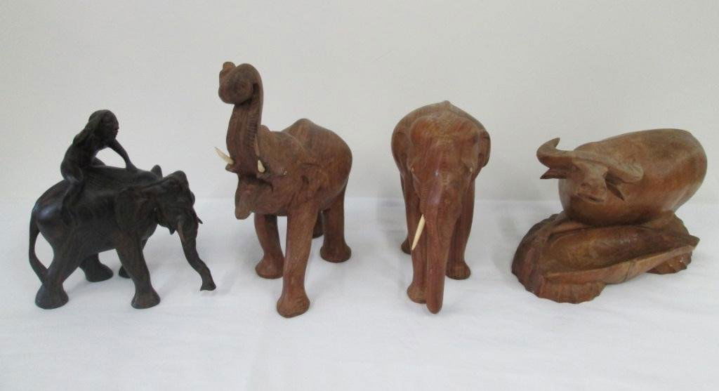 (4) CARVED EBONY & TEAK WOOD ANIMALS: Elephants and ox. One elephant is missing a tusk.