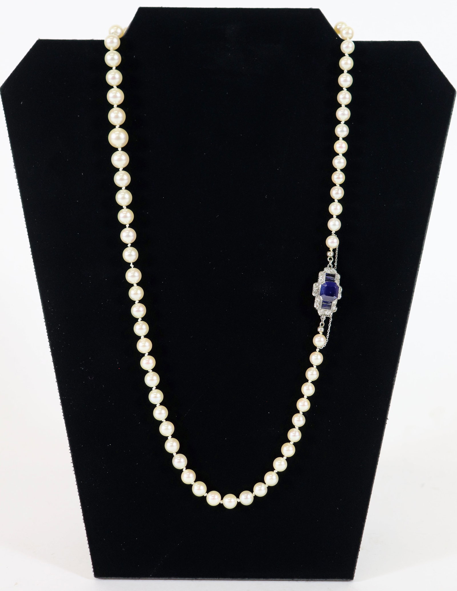 14K DIAMOND SAPPHIRE & PEARL NECKLACE: A set of hand strung pearls (range in size from 2.5mm to .75mm) with a 14K white gold clasp with approximately 1.25 carats of diamonds and 3 blue sapphires. Measures 21" long.