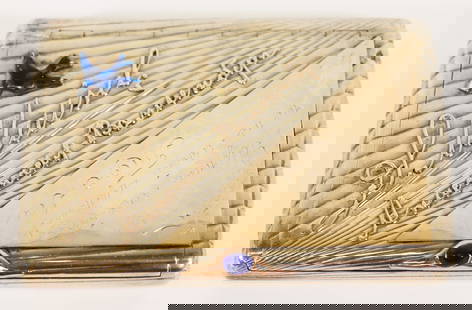 RUSSIAN GOLD & ENAMEL SILVER CIGARETTE CASE: This Russian cigarette case with hinged lid has a ribbed surface with blue enamel bird and sapphire embellishment, and mounted inscription. Mark of the joint-stock company of Moscow Goldsmiths Artels,