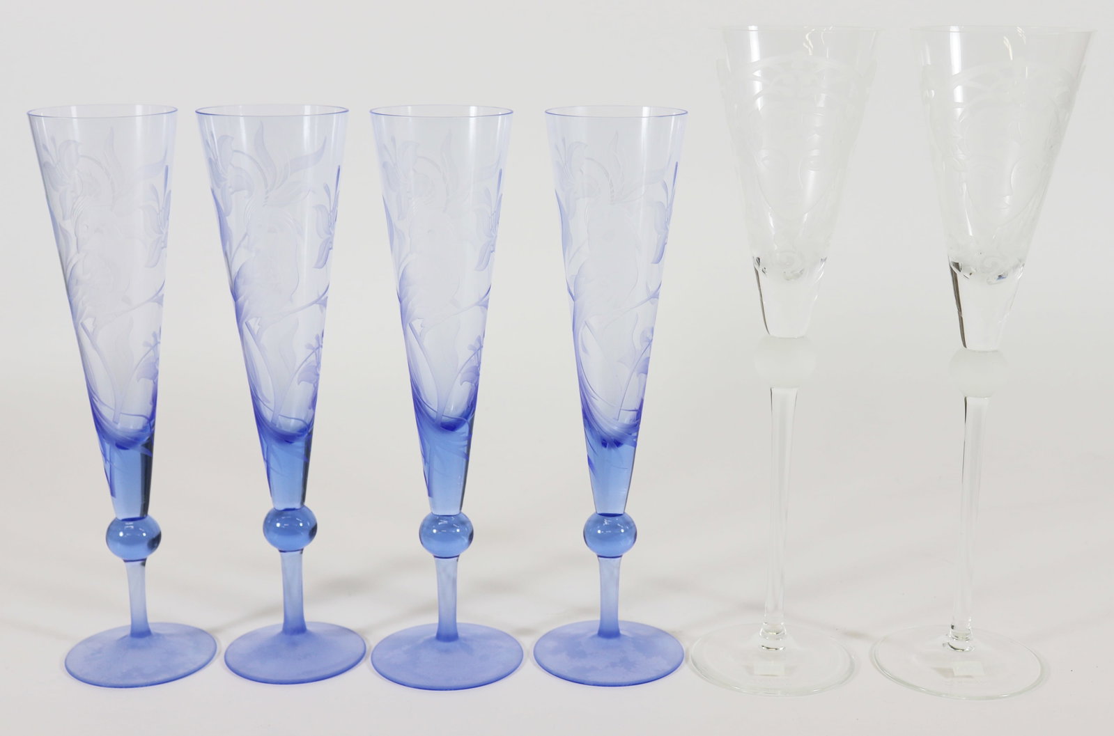 (6) FARINELLI WINE GLASSES - MEDUSA - PEACOCK: A set (4) matching blue etched fluted champagne or wine glasses with a peacock and flower design (10") and a pair of (2) etched glasses with a Medusa face (11.25"). New in boxes. Etched on base Farine