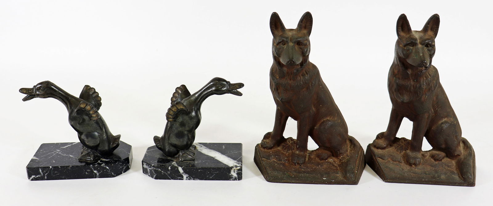COLLECTION OF BIRD & DOG BOOKENDS DOORSTOPS: A collection bird bookends and cast metal German Shepherd dog bookends or doorstops. Birds 5.5" wide 5.25" tall, dogs 9" tall. From the estate of Andrew Cunningham Ware.
