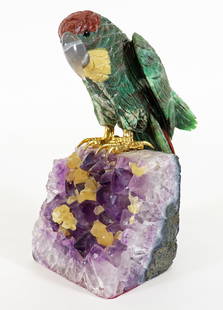 BRAZILIAN GEMSTONE PARROT SCULPTURE: A vibrant Brazilian hand carved semi-precious stone parrot sculpture perched on an amethyst geode base. Measures 8 1/2" H x 4" W x 7" D.