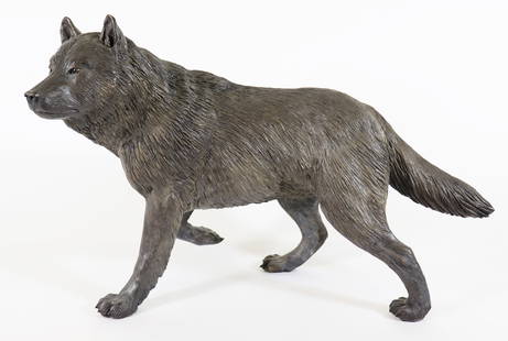 TOM HJORLEIFSON "ALPHA" WOLF BRONZE: Tom Hjorleifson (Canadian) Bronze "Alpha" gray male wolf in a standing guarded stance with right leg up as if poised to move with textured fur coat. Signed and numbered 1/12. Measures T 14" x L 21" x