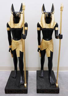 (2) TALL EGYPTIAN ANUBUS STATUES: A pair of carved wood Egyptian standing Anubis statue figures, marked 2003 and signed on base. Base accented with hieroglyphics. Measures 48" tall x 12 1/2" wide x19 1/2" deep. From the estate of Andr