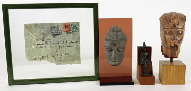 STONE AMENHOTEP III, BUDDHA HEAD & EGYPTIAN ITEMS: A carved stone fragment of Amenhotep III, an ancient Egyptian pharaoh. It is mounted on a wood stand. 7" x 2.5" x 2.5", a carved stone Buddha head fragment mounted on a plexiglass stand 6.75" x 3.5" x