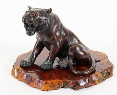 JAPANESE MEIJI PERIOD OKIMONO BRONZE TIGER: A Japanese Okimono bronze seated tiger sculpture from the Meiji period. Highly detailed with glass eyes and stripes with a burl wood base. Signed / stamped on the bottom. Measures 6" x 8" x 8 1/2". Fr