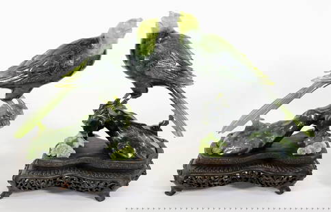 (2) CHINESE CARVED GREEN JADE BIRDS ON WOOD STANDS: A pair of carved dark spinach green that turns to a light green jadeite. Very fine detail down to the feathers. On carved pieced wood bases. 5 .5" x 6" x 2.5" not including stands. From the Andrew Cun