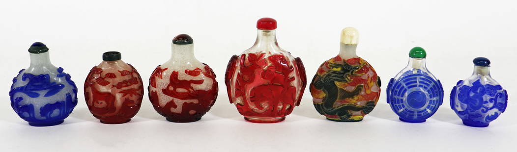 (7) CHINESE GLASS OVERLAY SNUFF BOTTLES: Includes a Chinese Peking glass tri color snuff bottle with red, yellow and green overlay with a dragon motif. 3 1/4", (3) blue overlay glass one with horses, one with pagoda and serpents and a geomet