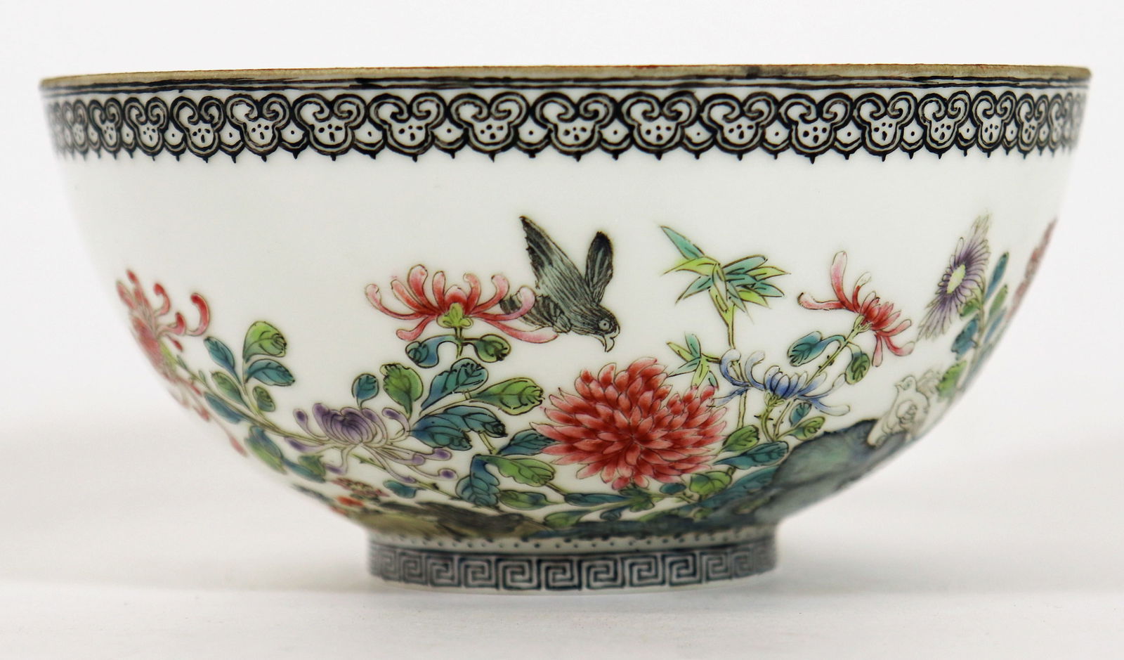 CHINESE QING DYNASTY FAMILLE ROSE BOWL: Chinese Qing Dynasty round Famille Rose bowl. Hand painted with birds, flowers, and calligraphy. Blue & white mark on bottom. Measures approximately 5" wide 2.5" tall. From the Estate of Andrew Cunnin