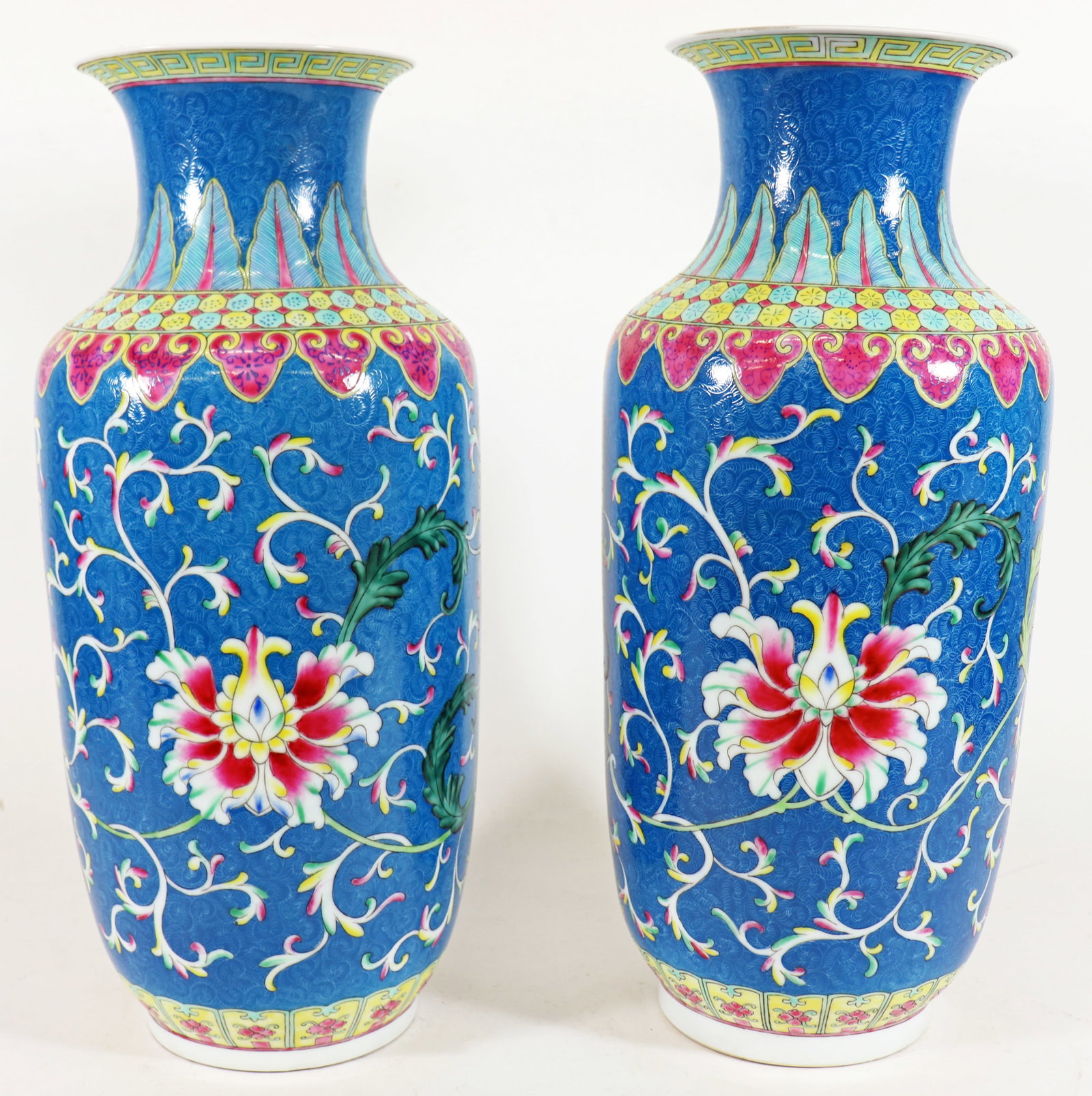 (2) CHINESE BLUE PORCELAIN VASES: Pair of Chinese porcelain vases with floral and vine scroll work design in cornflower blue with pink, green, yellow, and white colors. 18" tall 7" wide.