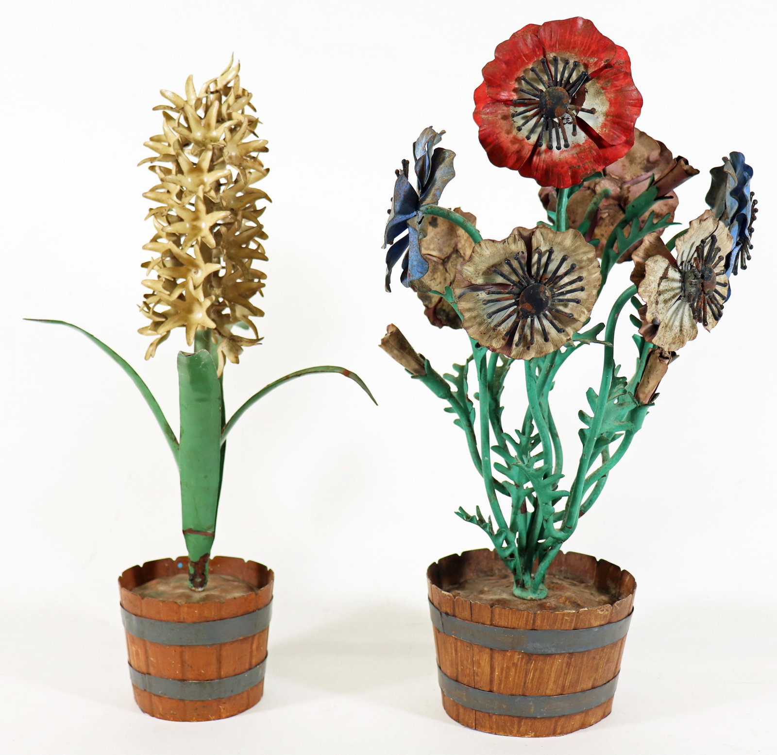 (2) VINTAGE METAL TOLEWARE FLOWERS IN BARREL POTS: Pair of vintage flower pots including a painted metal toleware basket of assorted colorful flowers in a wine barrel style metal pot 16" tall and a white hyacinth metal flower in a barrel style pot 15.