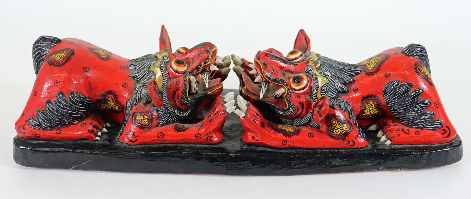 BALI CARVED POLYCHROME WOOD DOGS FIGURE: Hand painted wood figure of two dog / mythological animals facing each other. Measures 18" x 5.5" wide.
