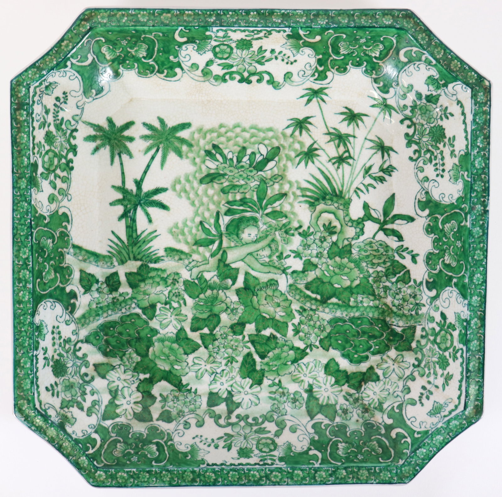 CHINESE GREEN PORCELAIN OCTAGON TRAY: Vintage Chinese porcelain green and white glazed tray depicts a cherub surrounded by trees, flowers, red seal marked on underside. This octagon shaped dish measures 13" x13".