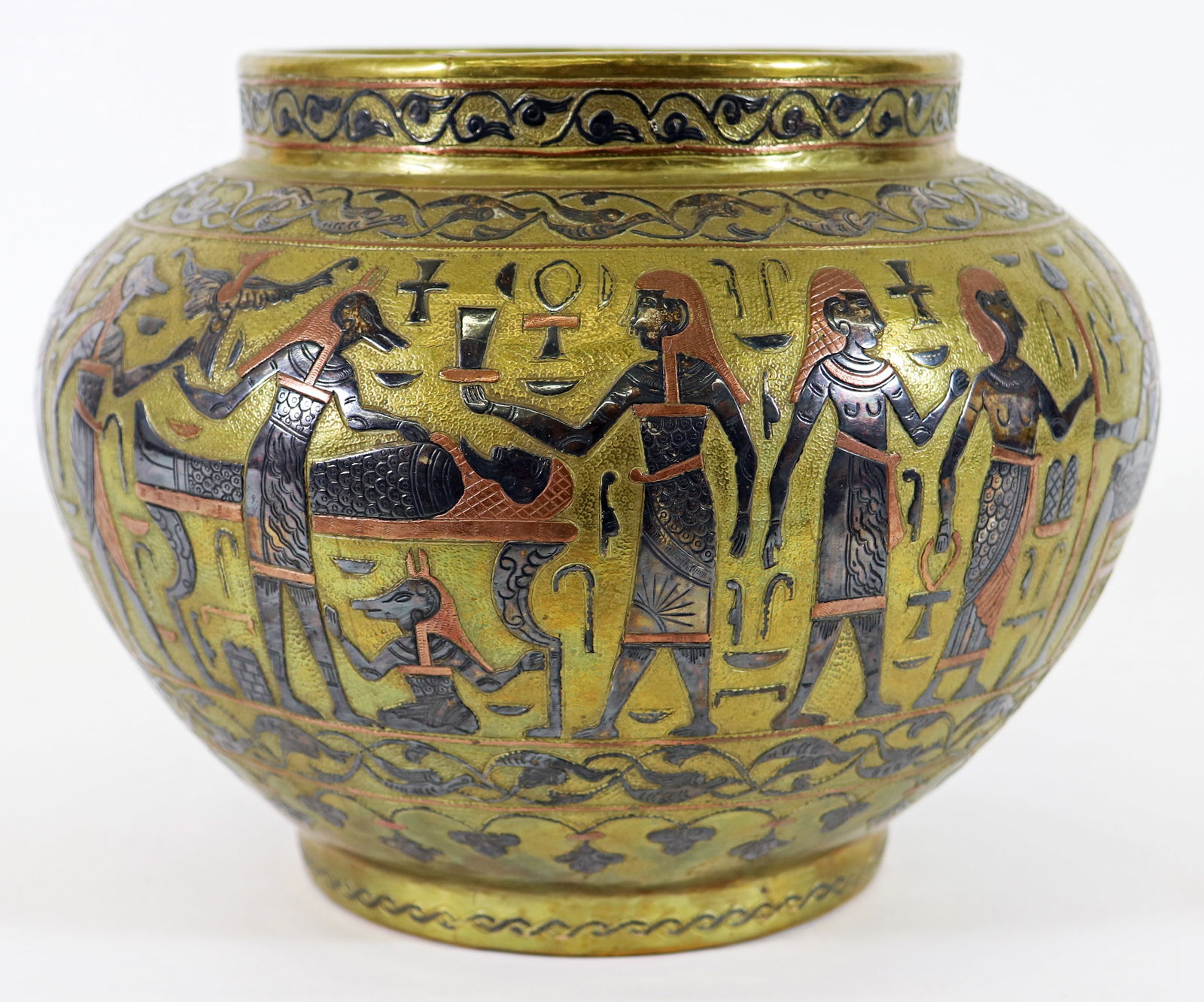 EGYPTIAN MIXED METAL VASE: Egyptian tricolor mixed metal vase surrounded with figures, pyramids, birds, and more. Measures 9.5" wide 7" tall.