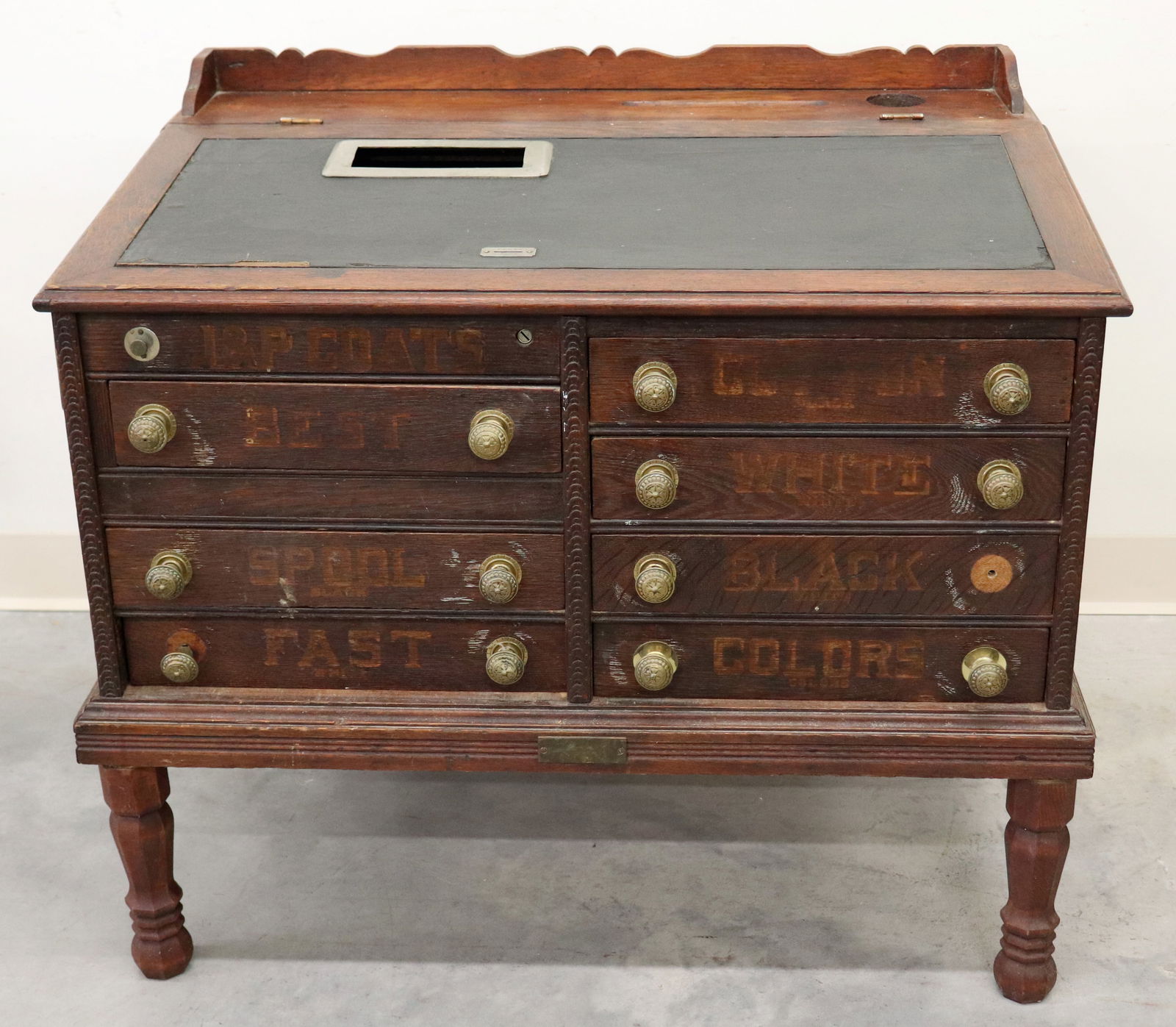 ANTIQUE J & P COATS CASH REGISTER SPOOL CABINET: A very rare cash register that was consigned by J & P Coats Thread Company to the store agent owner's that would sell their product exclusively. It has a slanted top with a slot for a "penny" with a c