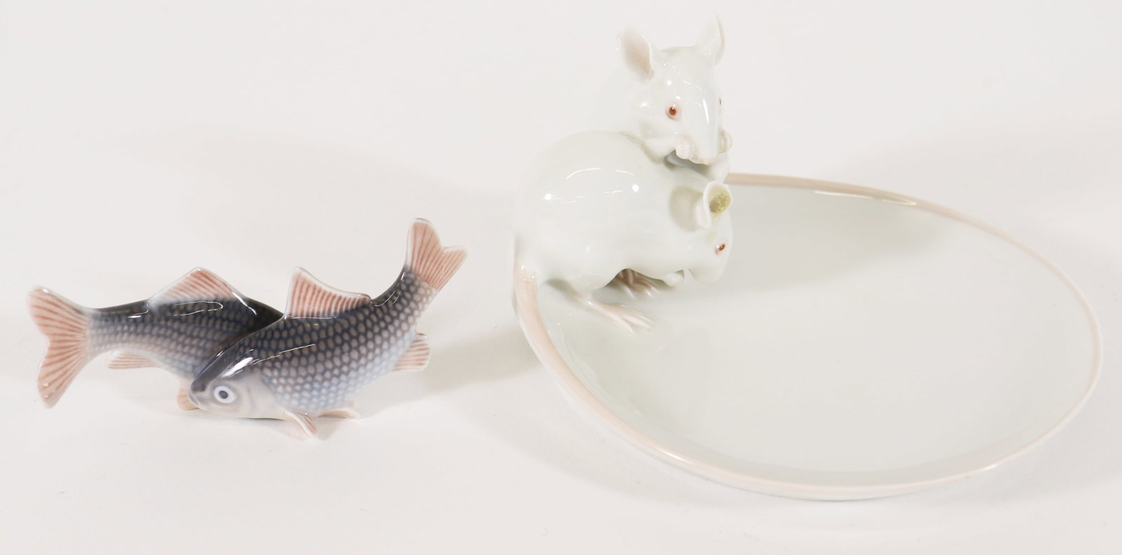 (2) ROYAL COPENHAGEN PORCELAIN FIGURINES: Two Royal Copenhagen porcelain figurines, made in Denmark, includes a double minnow figurine #2870, measures 1 1/2" x 4 1/4" x 1 1/2", and a small trinket / cheese plate with a pair of mice #1562, tin