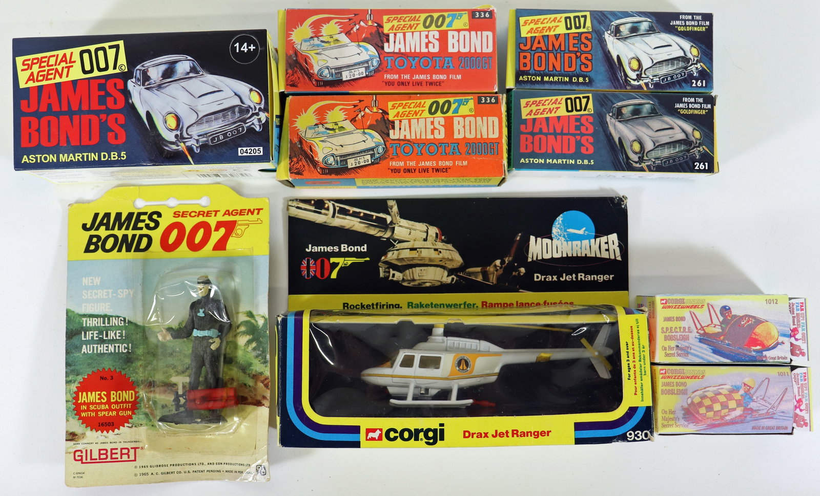 CORGI JAMES BOND 007 DIE CAST TOYS: A collection of Corgi Special Agent 007 James Bond toys. Includes a Moonraker Drax Jet Ranger 930, (2) Toyota GT2000 #336, an Aston Martin D.B.5 #04205, an Aston Martin D.B.5 #261, a Bob Sleigh #1012,