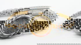 ROLEX OYSTER PERPETUAL STAINLESS & GOLD WRISTWATCH: Ladies Rolex Oyster Perpetual stainless steel and gold superlative chronometer watch with a champagne dial. Includes paperwork and is in working condition. Some age related wear, scratches & wear to c