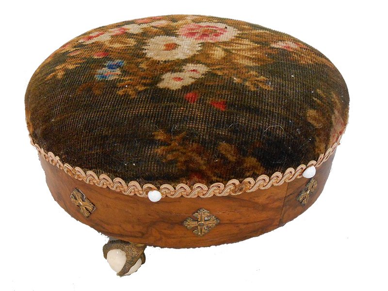 VICTORIAN ROUND NEEDLEPOINT FOOT STOOL: With ball & claw feet holding white porcelain. Measures 6" tall 11" wide.