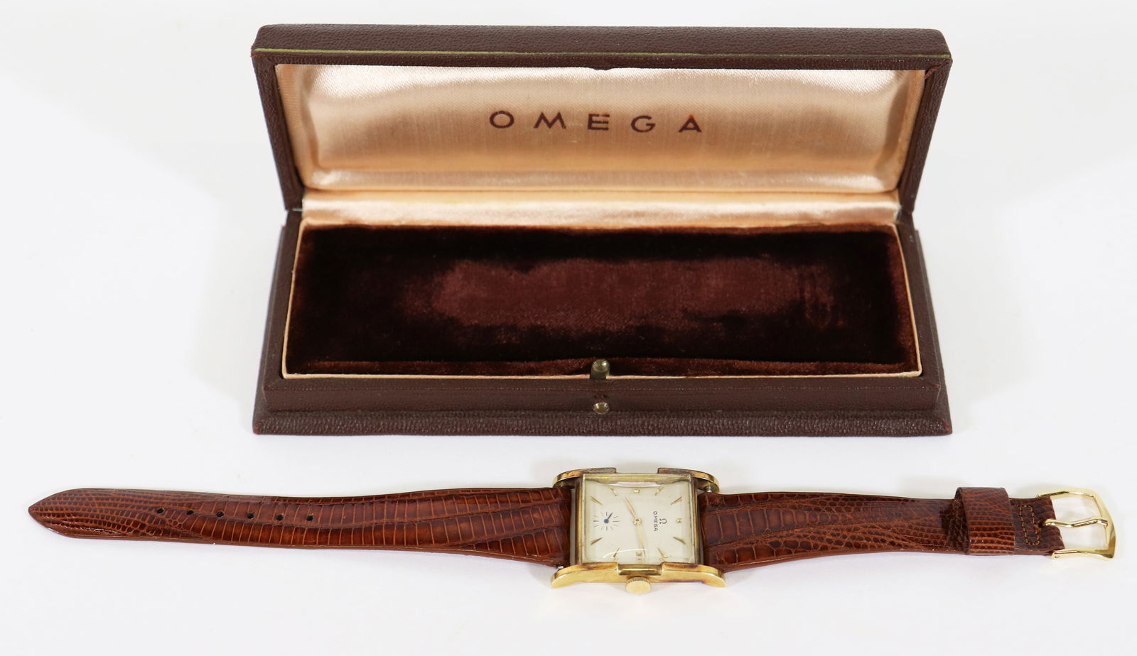 VINTAGE MEN'S 18K OMEGA WRISTWATCH & BOX: Vintage Men's 18KT yellow gold Omega tank style wristwatch with vintage Omega box. Face measures approximately 1" wide x 1 3/8" wide. Working.