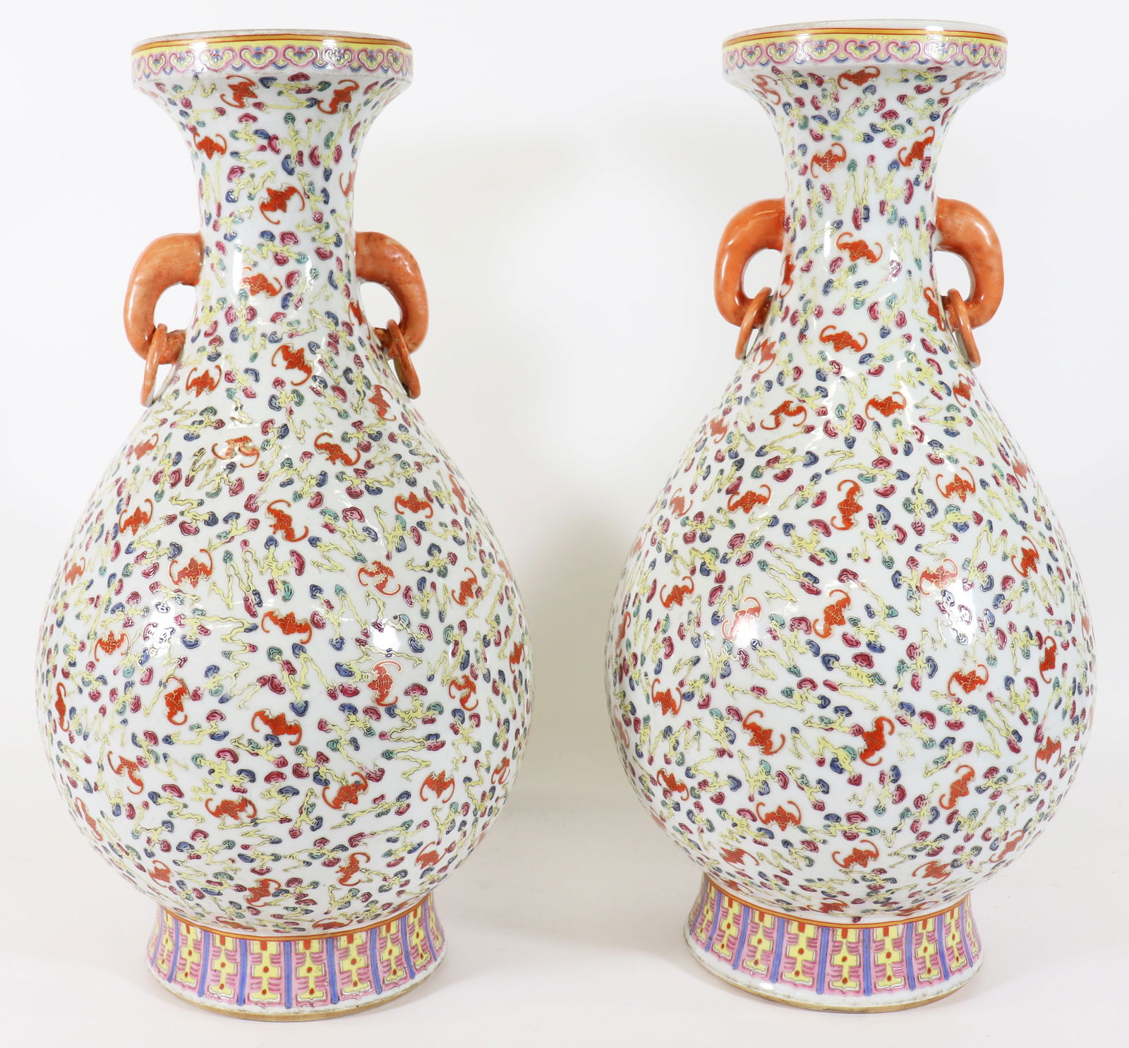 (2) CHINESE PORCELAIN FAMILLE ROSE VASES: A pair of Chinese Famille rose vases with all over pattern of small colorful bats and clouds, each vase has two applied handles, and a red six character reign mark on the underside. Measures 18 1/4" t