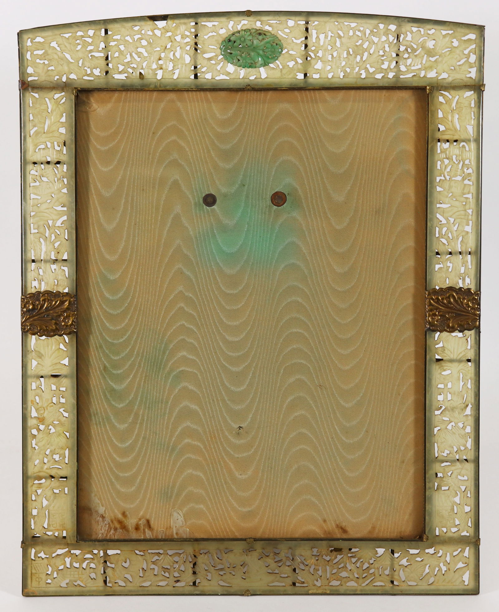 LIGHT CARVED JADE PICTURE FRAME: A vintage Chinese carved jade picture frame with open work floral and leaf pattern. A jade carved pendant is centered at the top. (Crack to corner and glass and chip to top middle jade). Measures 16 1