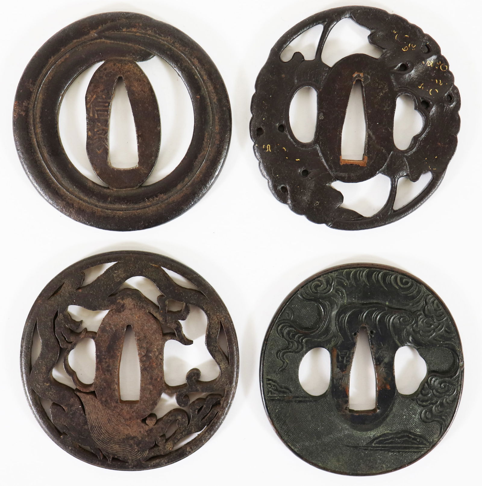 (4) SIGNED JAPANESE TSUBA SAMURAI SWORD GUARDS: A collection of 4 Edo Period Tsuba sword guards, all signed in Japanese. They are an iron mixed metal. and range in size from approximately 2 3/4 to 3". These are part of a large collection of samurai