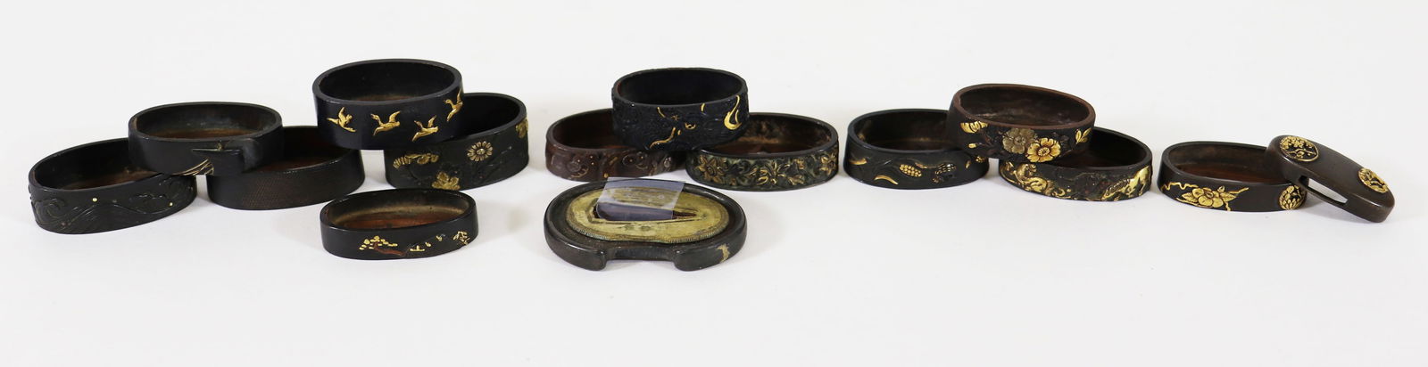 (15) JAPANESE FUCHI AND KASHIRA SWORD DECORATIONS: Antique Japanese sword decorations including a group of 15 mixed metal fuchi and a matching set of one fuchi and kashira. Intricate designs and accents. Some signed. From the Estate of Bob Lightner, J
