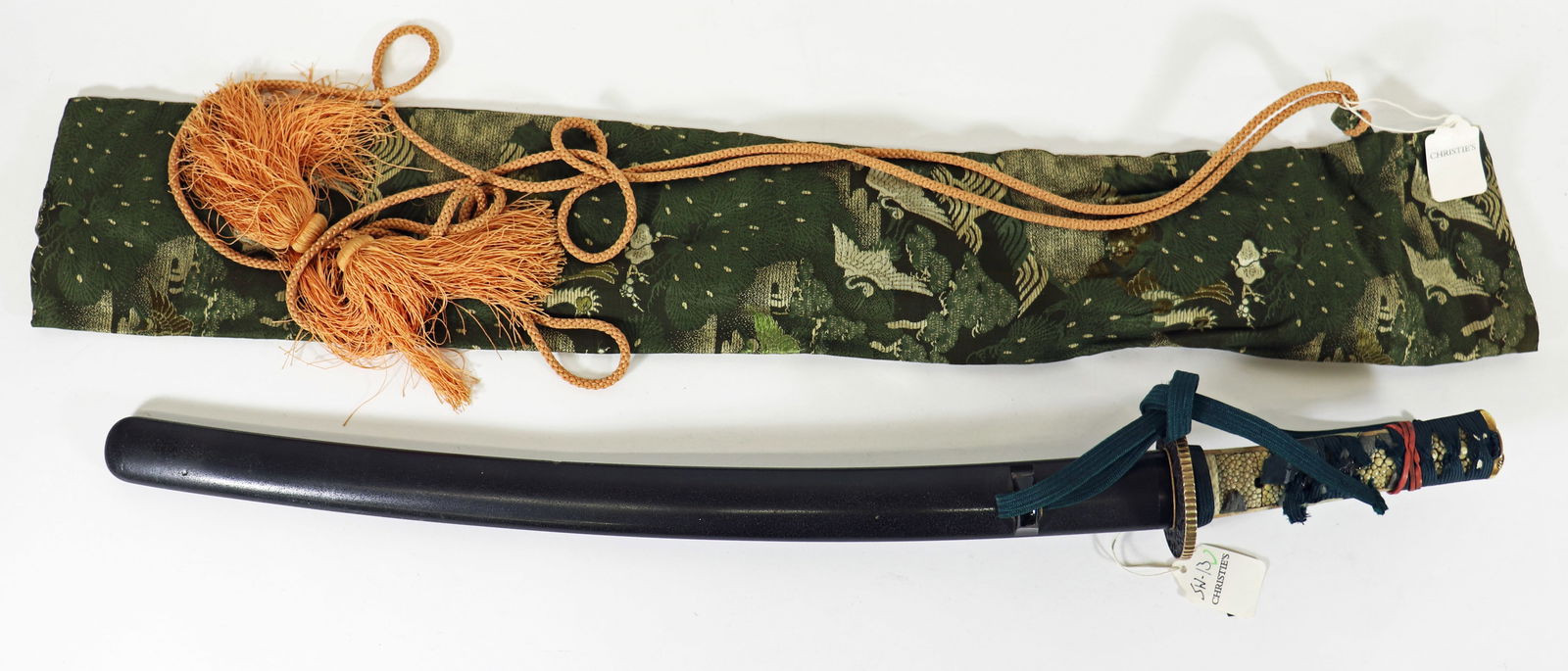 JAPANESE WAKIZASHI SAMURAI SWORD: A Japanese Wakizashi with a 20" blacde. It has a decorated Tsuba with gold tone trim and spacer. The handle is woven (with some losses) with 2 menuki. With silk carrying pouch. 32" total length. This