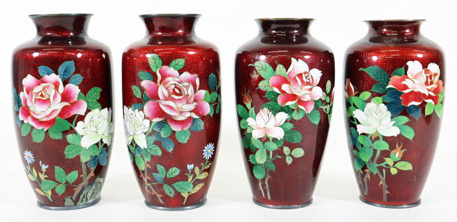 (4) JAPANESE RED FLORAL ENAMEL GINBARI VASES: A set of four Japanese cloisonne enamel Gin Bari vases, pigeon blood red with floral and bamboo shoots design, marked silver on bottom rim each measures approx 7 1/2" x 4" . Age related wear, some chi