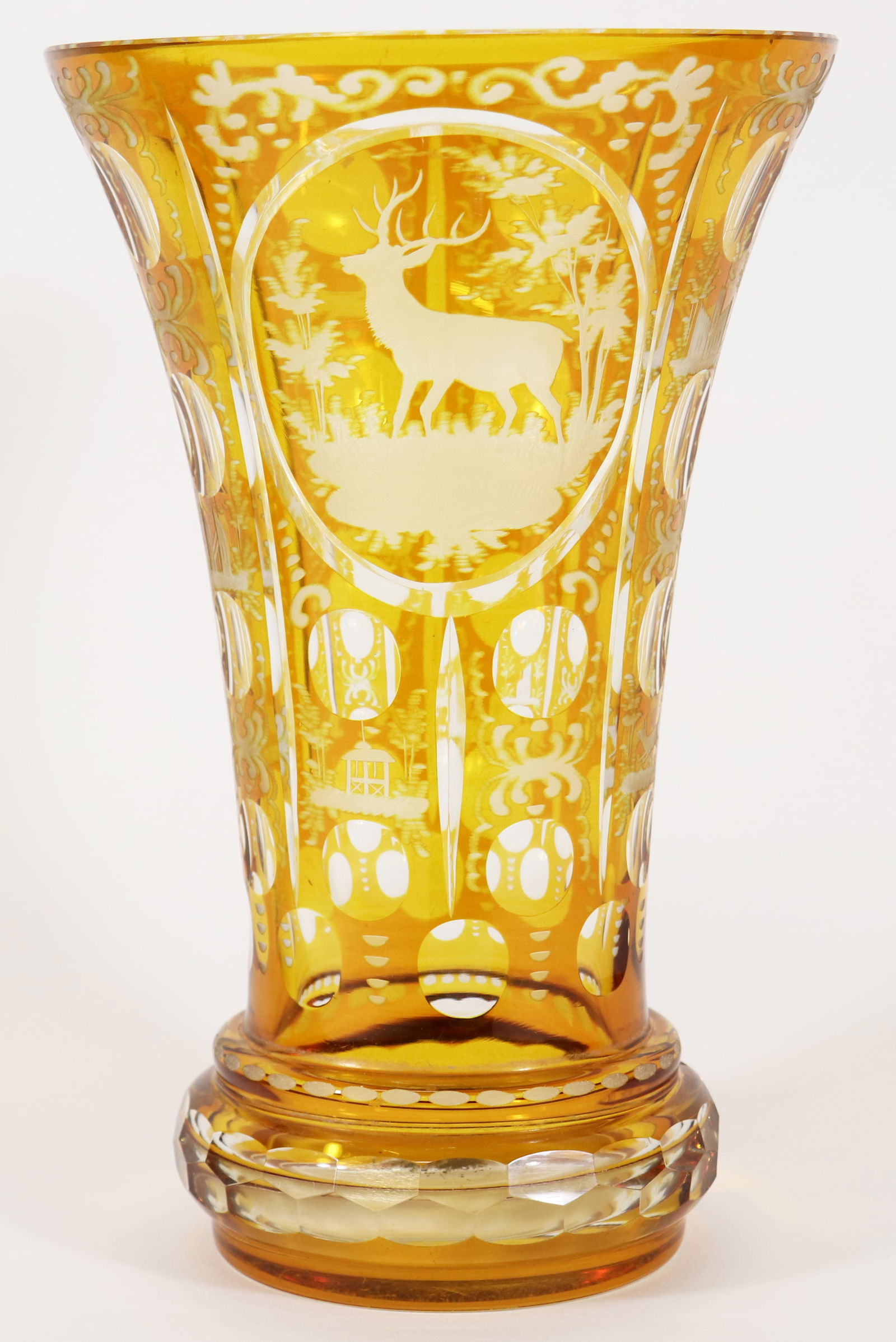 BOHEMIAN CUT TO CLEAR STAG VASE: Bohemian yellow cut to clear glass vase with a stag. Measures 10.5" tall 6.75" wide at top.