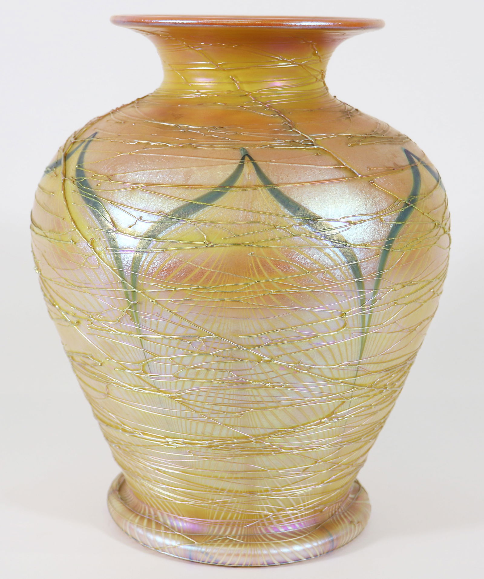 DURAND THREADED PULLED FEATHER VASE: An unsigned vase attributed to Durand. It has a gold pulled threaded design with yellow, orange and green colors. Measures 11" x 9".