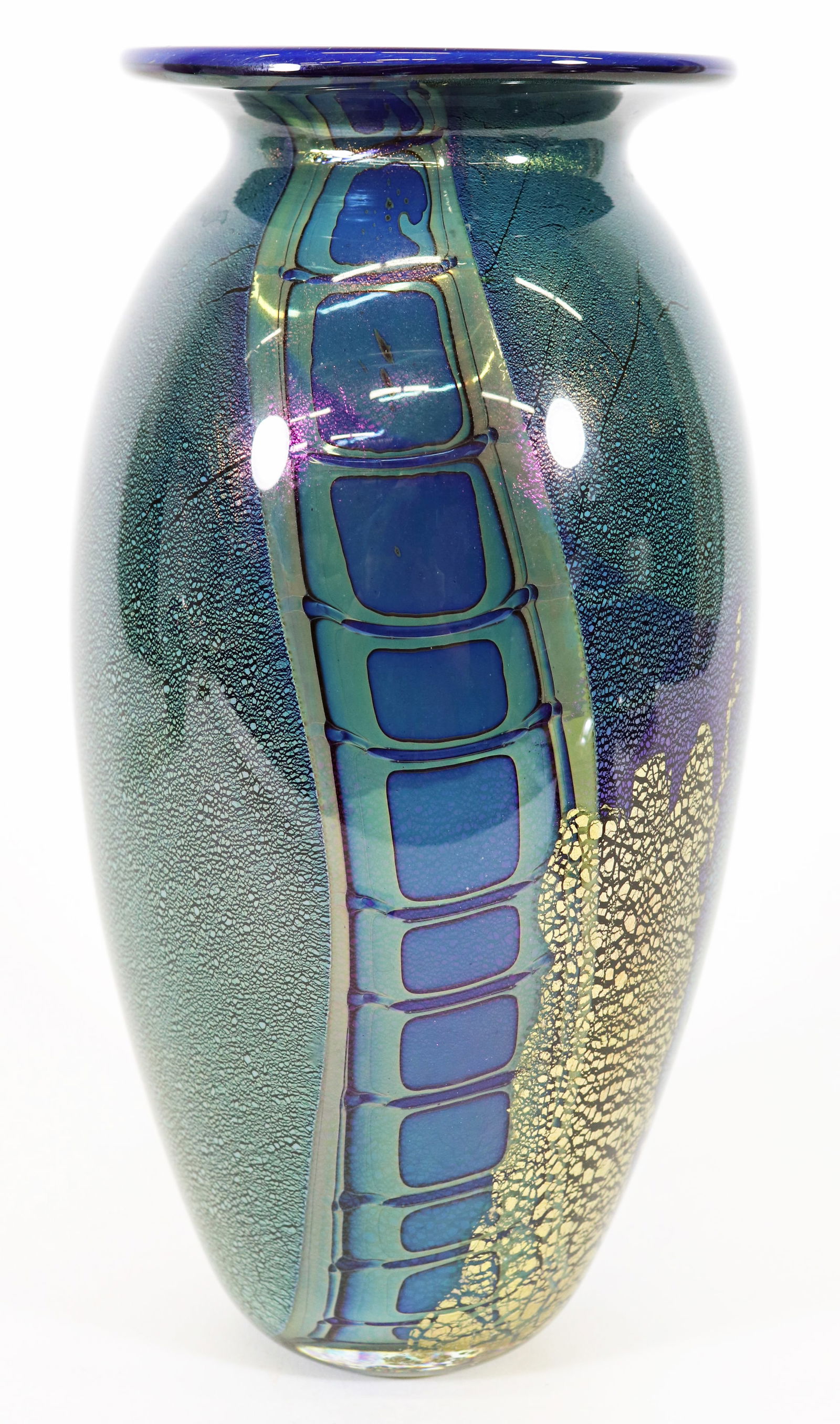 ROBERT EICKHOLT 2007 ART GLASS VASE 10.5": Robert Eickolt signed and dated vase with blues, greens and gold colors. It measures 10.5" x 5.5". Ships in a 14" x 14" x 14" box.