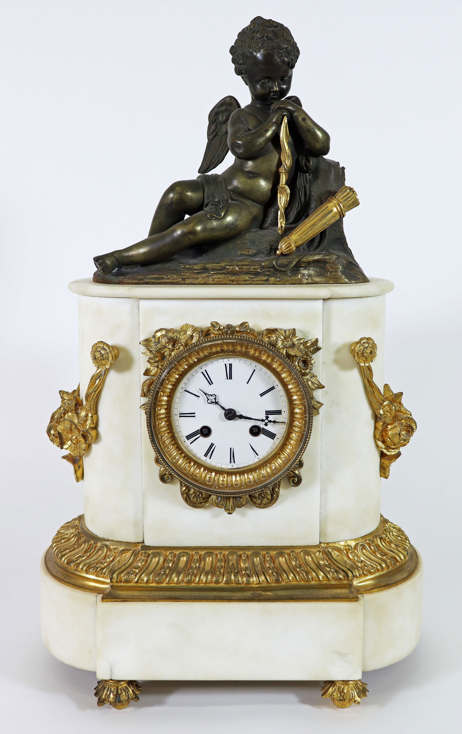 ANTIQUE FRENCH GILT MARBLE CLOCK: Antique French gold gilt ormolu accented marble clock with cherub / cupid on top. Includes pendulum. Not tested. Measures 19" tall 11" x 7" wide.