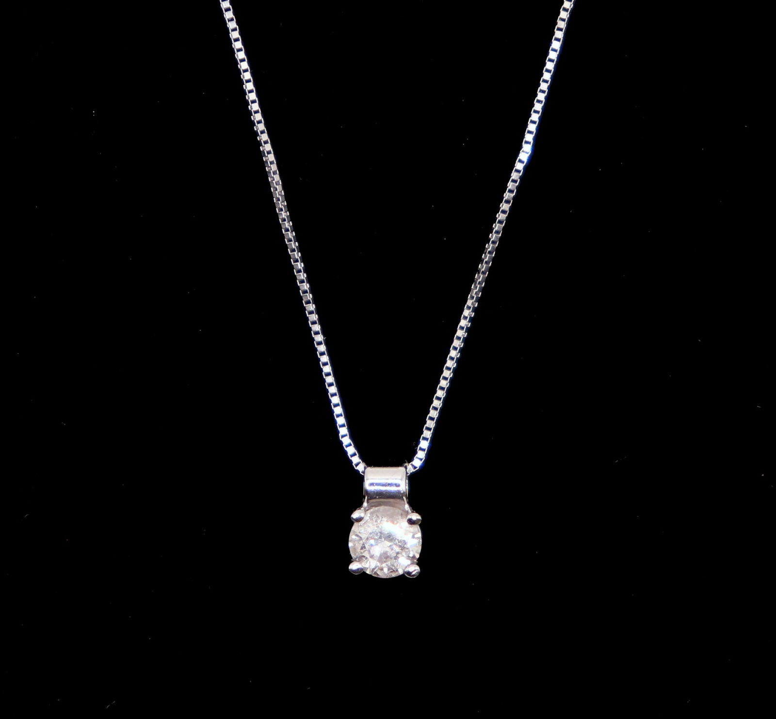 14K WHITE GOLD DIAMOND SOLITARE NECKLACE: A sparkling .25 carat diamond solitaire with a 14K white gold 16" chain. Total weight 1.5g