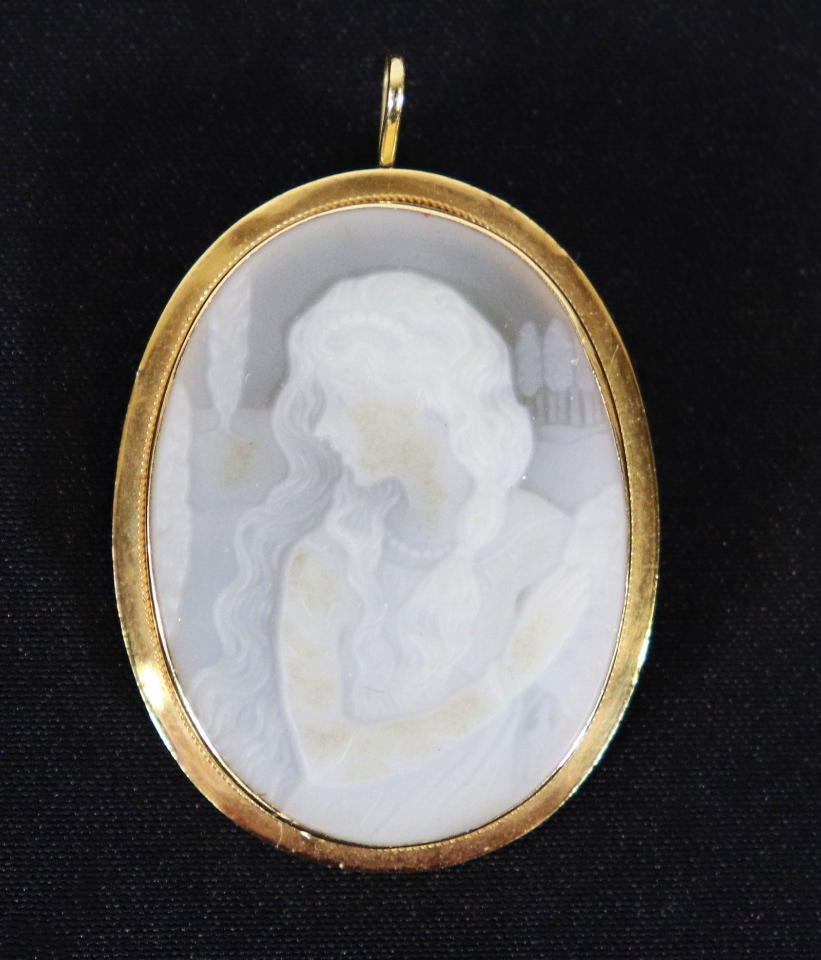 18K GOLD "FLOWING HAIR" CAMEO PENDANT PIN PENDANT: An 18K yellow gold framed cameo with a flowing hair lady. Measures 1.75" x 1". Can be worn as a pendant or a brooch.