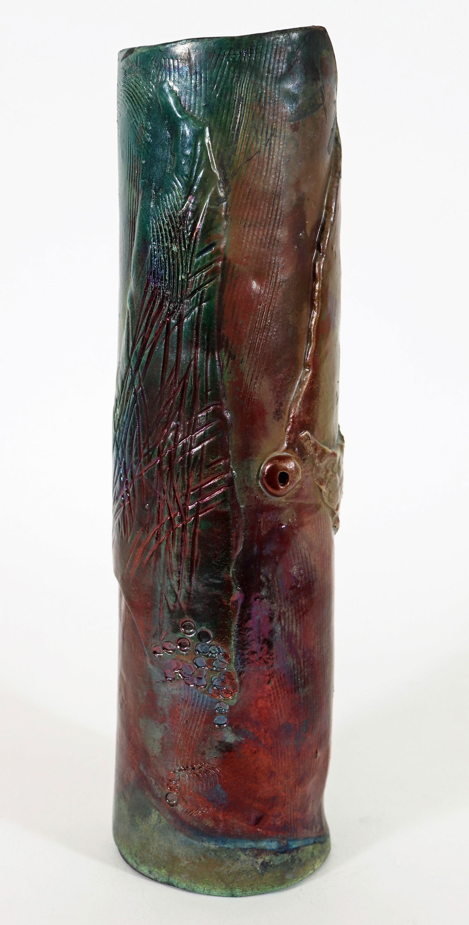 IRIDESCENT RAKU POTTERY VASE: Multi color iridescent Raky pottery vase. Signed on bottom. Measures 13.75" tall 3.5" wide.