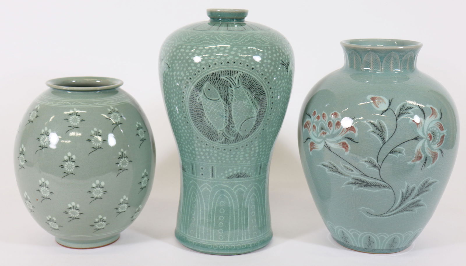 (3) KOREAN CELADON MAEBYEONG VASES: Includes a Korean Celadon Maebyeong vase with two fish and lotus design, measures 10" x 5 3/4", artist's signature on bottom, a Korean Celadon vase with floral design with earthy red petals, measures