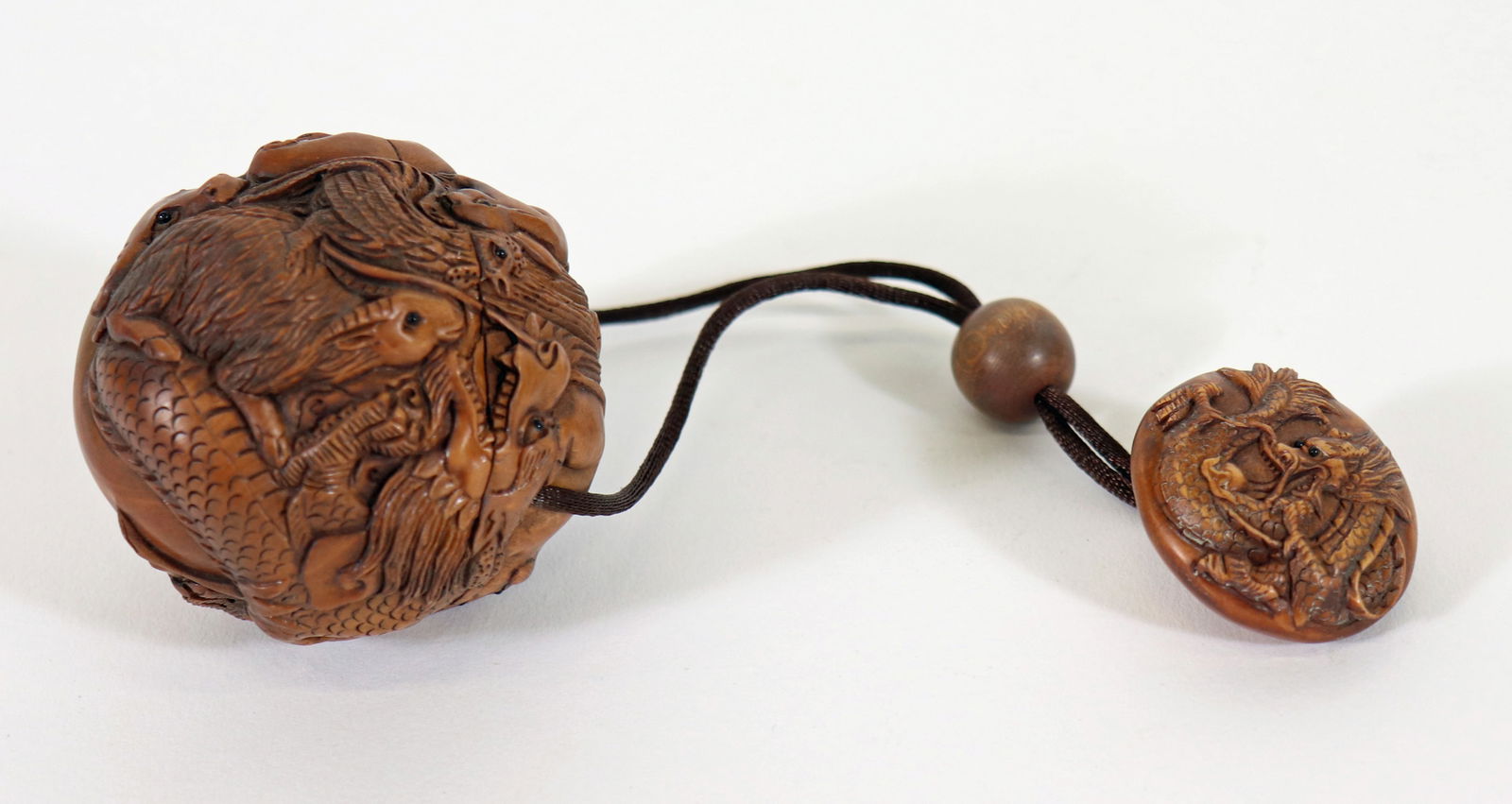 JAPANESE WOOD ZODIAC INRO NETSUKE: Japanese signed carved wood Inro Netsuke with a 2.5" zodiac ball box and round dragon netsuke.