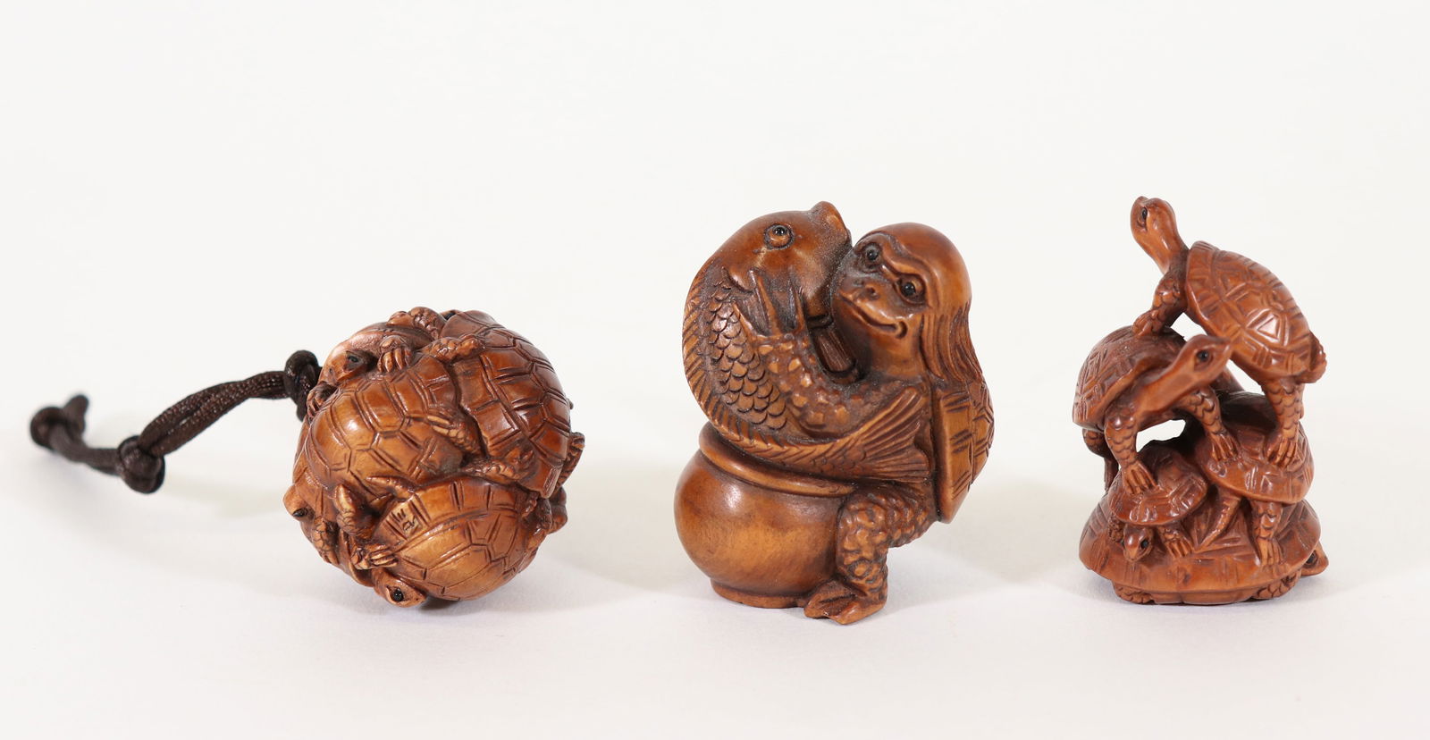 (3) JAPANESE NETSUKE - KAPPA & TURTLES: Three signed Japanese carved wood netsuke including a Kappa with fish and turtles. 1.5" to 2"