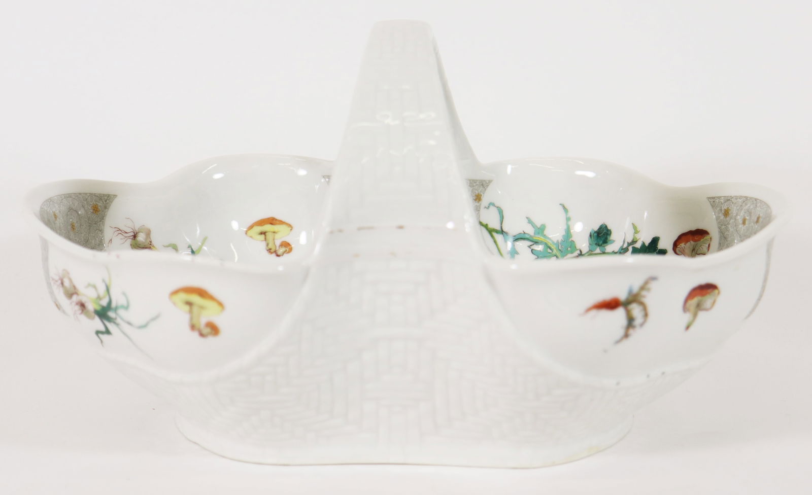ANTIQUE OVAL HAVILAND LIMOGES MUSHROOM BOWL: An antique Haviland Limoges mushroom basket bowl with center handle and decorated with vegetables and mushrooms. Mark on bottom of bowl. Measures 6 1/2 x 10 1/2" x 8".