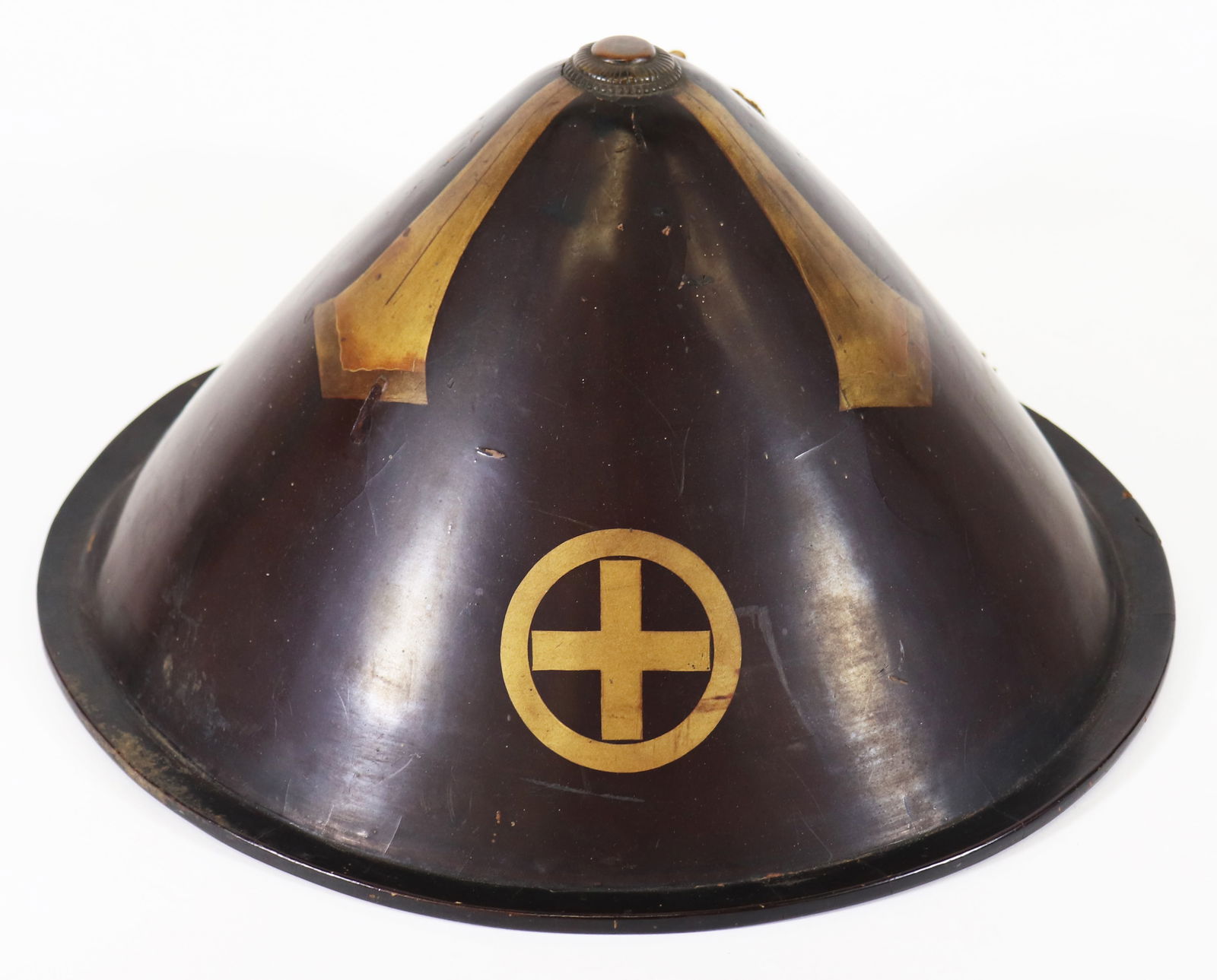 JAPANESE LACQUERED JINGASA WAR HAT: Japanese lacquered Jingasa war hat, attributed to the Edo period, with a gold painted clan crest on the front, gold tassel, and red interior. Measures 13.75" x 9.5". From the estate of Japanese