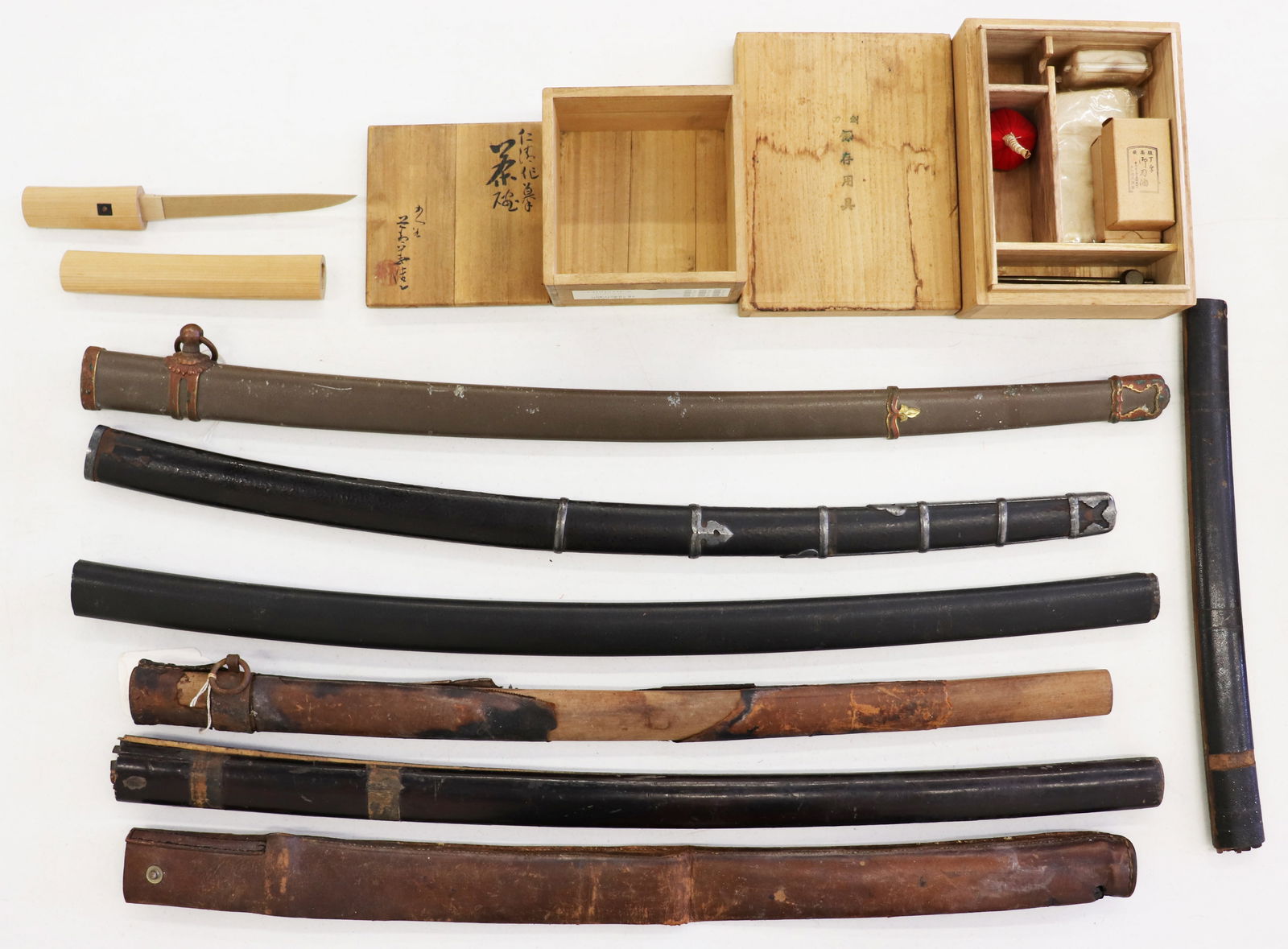 JAPANESE SWORD SHEATHS & MORE: Collection of Japanese items including scabbards, wooden tanto dagger, Samurai Katana sword maintenence cleaning kit in box, and a wooden Japanese box. Age related wear. Ships in a 36" x 6" x 30" box.