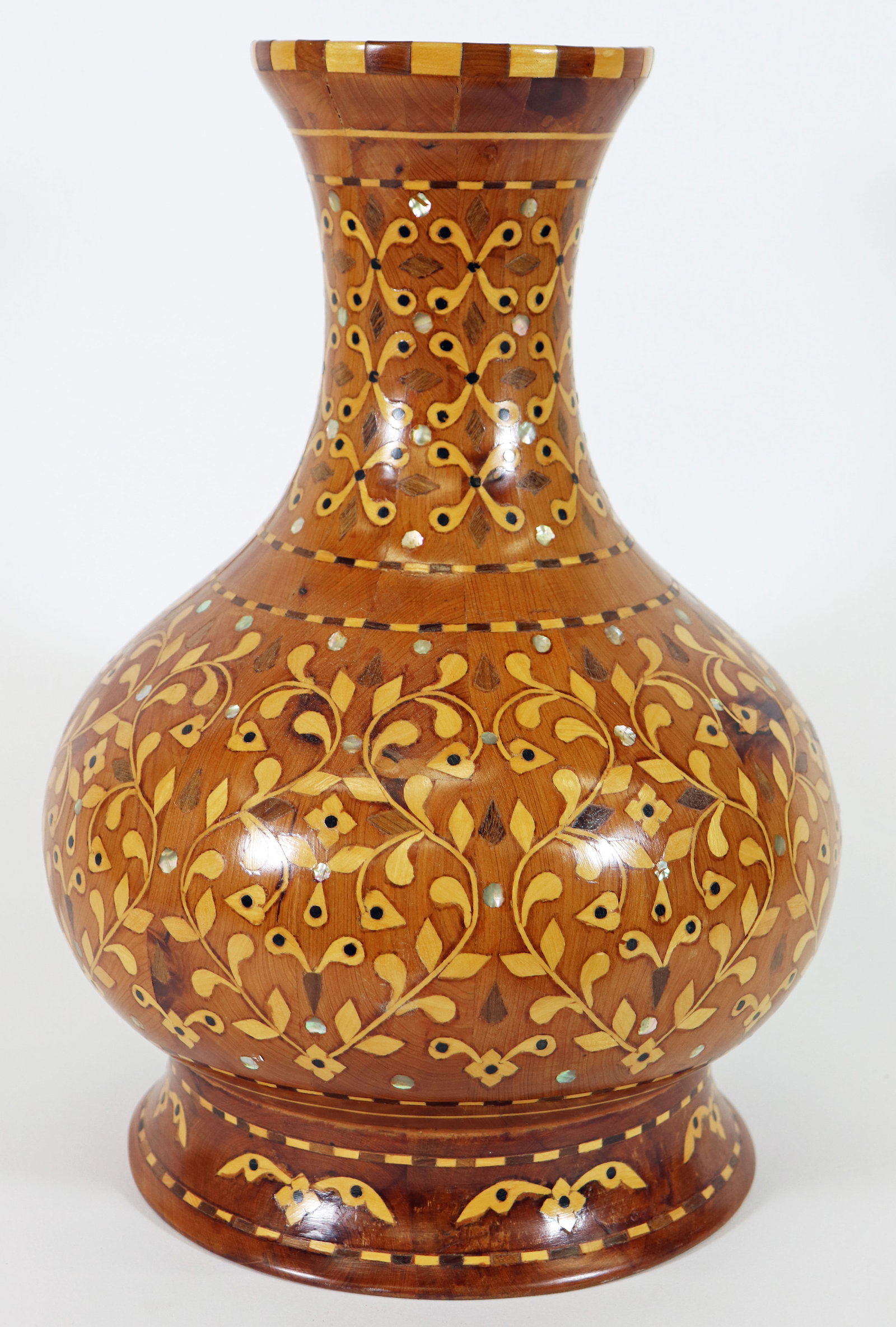 MOROCCAN MOTHER OF PEARL INLAID WOOD VESSEL: Stunning marquetry vase with mother of pearl inlay forming a vine and floral design. 13" x 9".