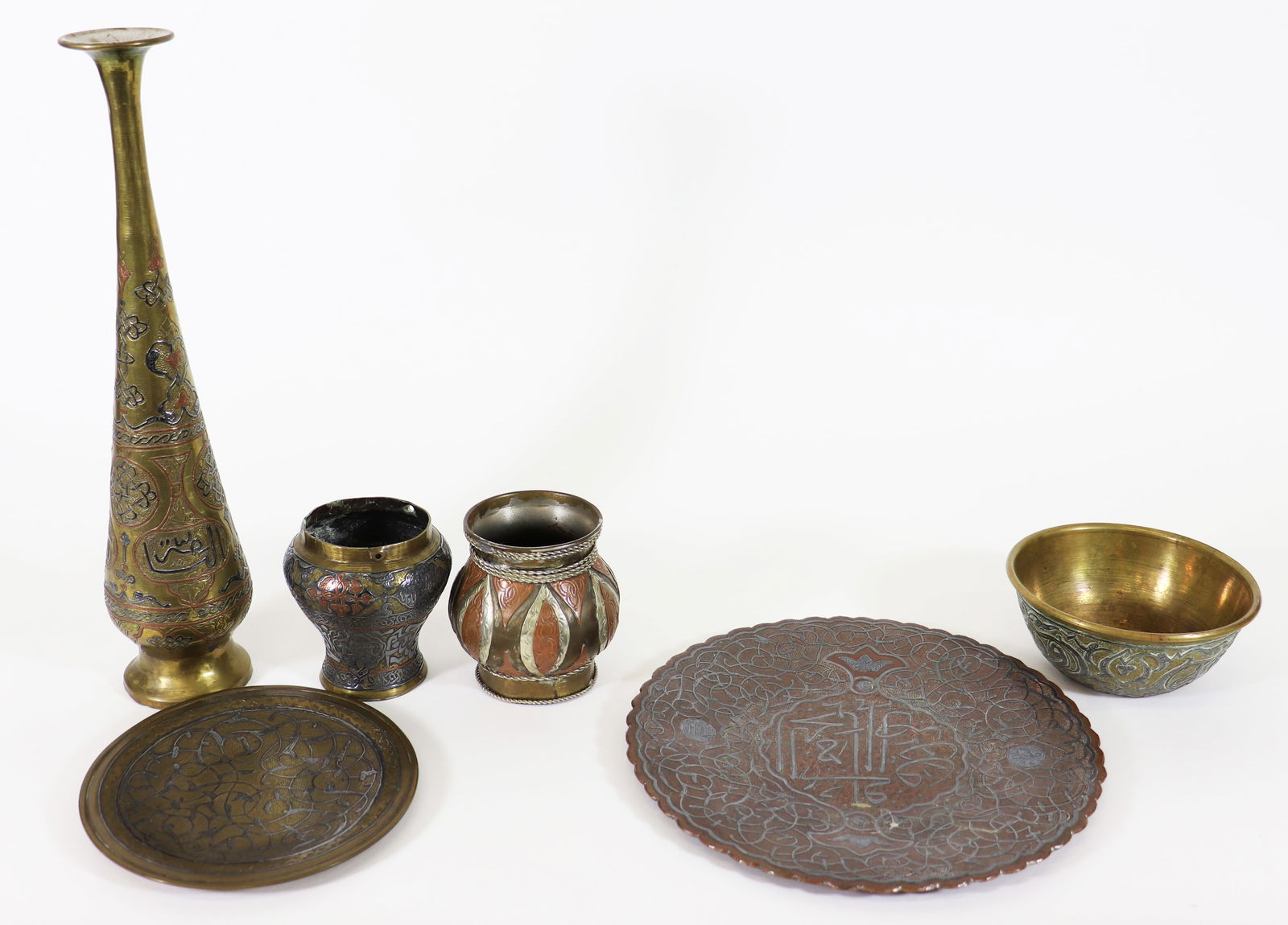ANTIQUE MIDDLE EASTERN METALWARE COLLECTION: A collection of Persian mixed metal items to include a 12.5" vase, a pair of smaller vessels 3.5", a mixed metal bowl and 2 Persian copper and brass plates. Ships in a 15" x 14" x 7" box