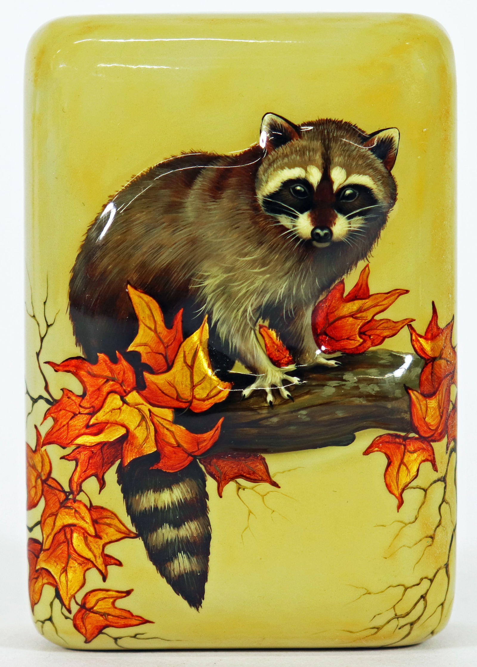 FEDOSKINO RUSSIAN LACQUER BOX RACCOON: Unique Russian 3D lacquered box handmade in the Fedoskino Village. It depicts a front facing Raccoon on a branch with beautiful orange fall leaves, against a light colored enamel background. Lid
