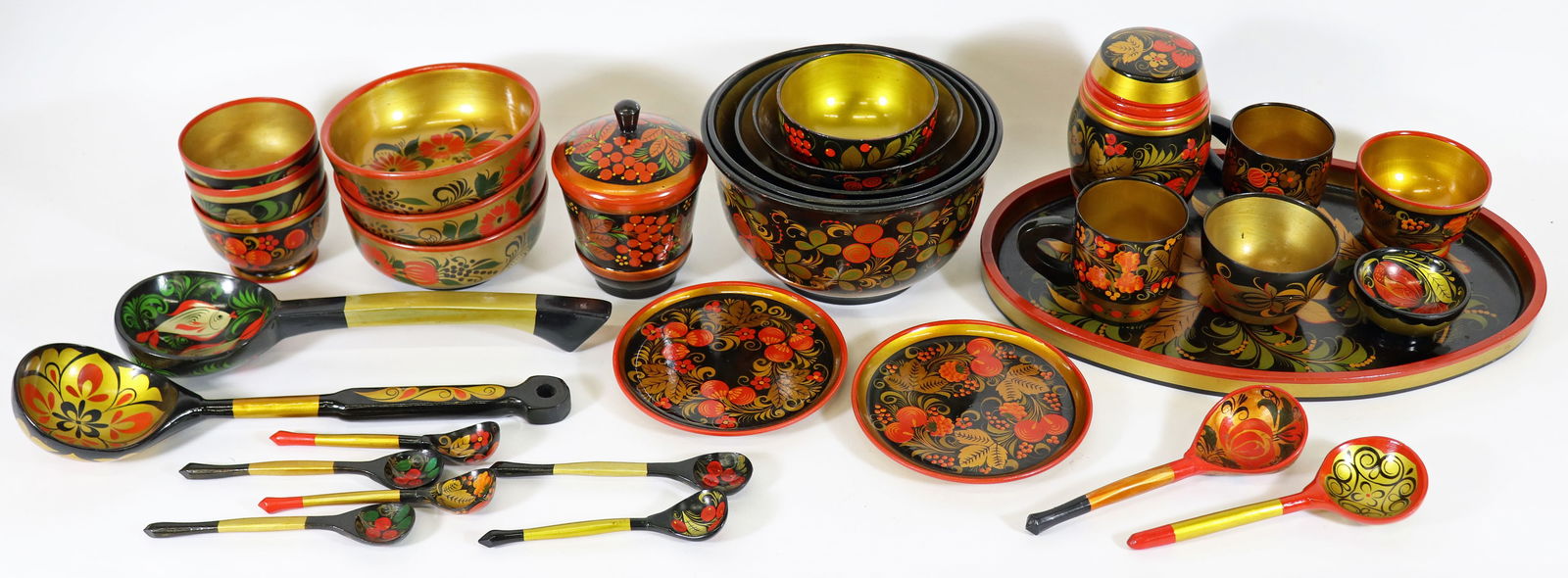 31 PC RUSSIAN FOLK ART LACQUER COLLECTION: A large collection of Russian Khokhloma bowls, platter, spoons and containers. Some used for serving Borsch. Ships in a 14" x 14" x 14" box.