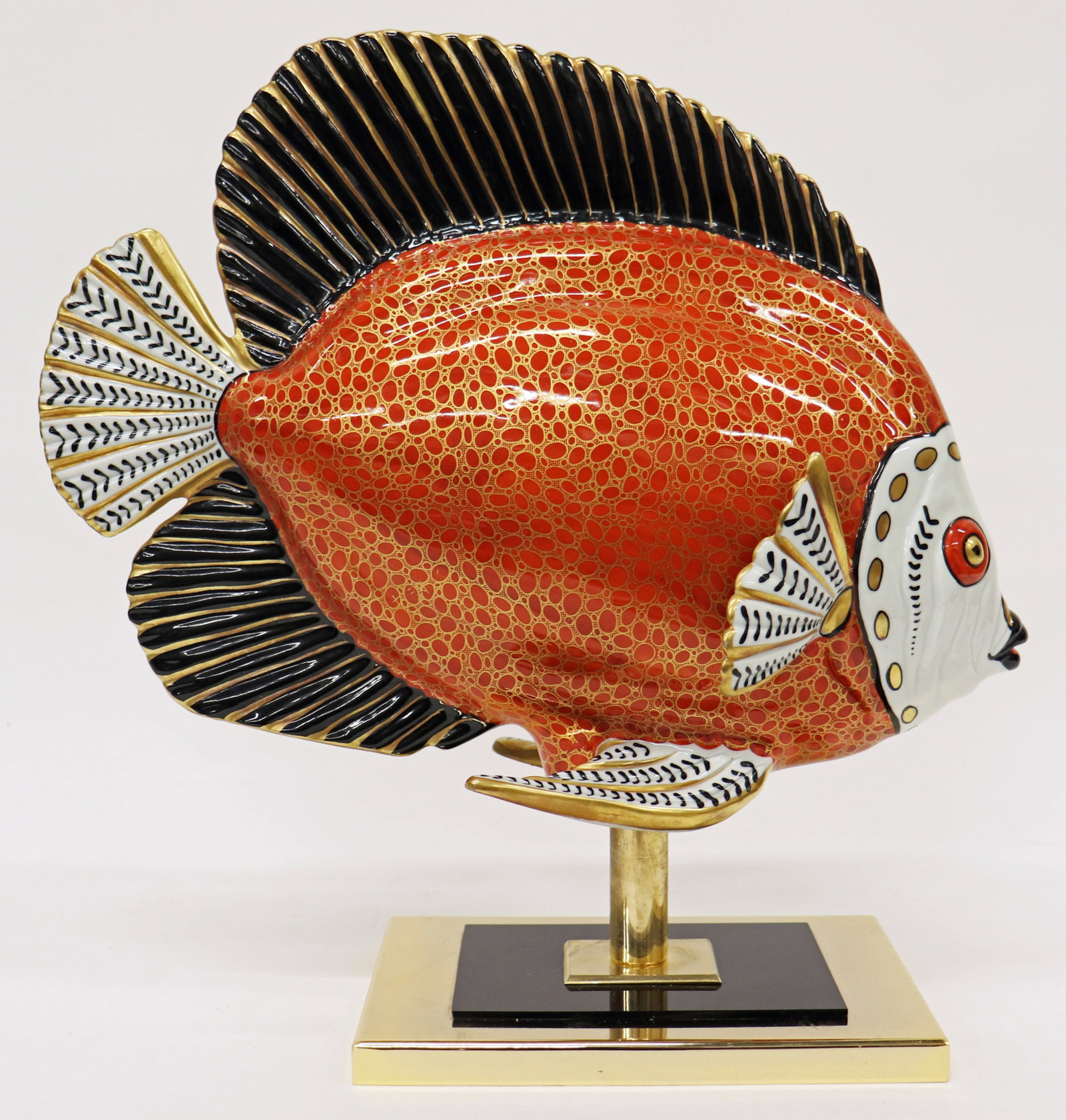 MANIFFATURA ARTISTICA ITALY ORANGE FISH SCULPTURE: Manifattura Artistica Le Porcellane Italian orange, black, white, and gold painted porcelain fish sculpture. Measures 14.5" x 6" wide 14.5" tall.