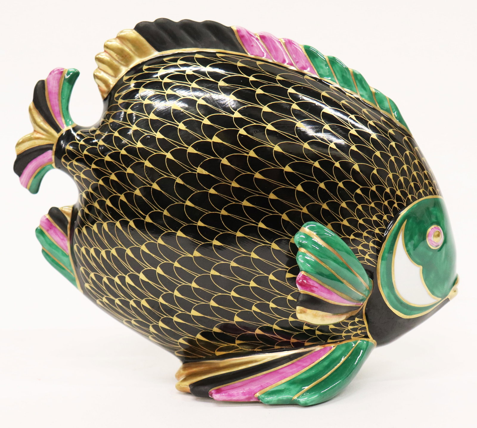 MANIFFATURA ARTISTICA BLACK PORCELAIN FISH: Manifattura Artistica Le Porcellane Italian black, gold, green, and pink porcelain fish sculpture. Measures 9.5" wide 8.25" tall.