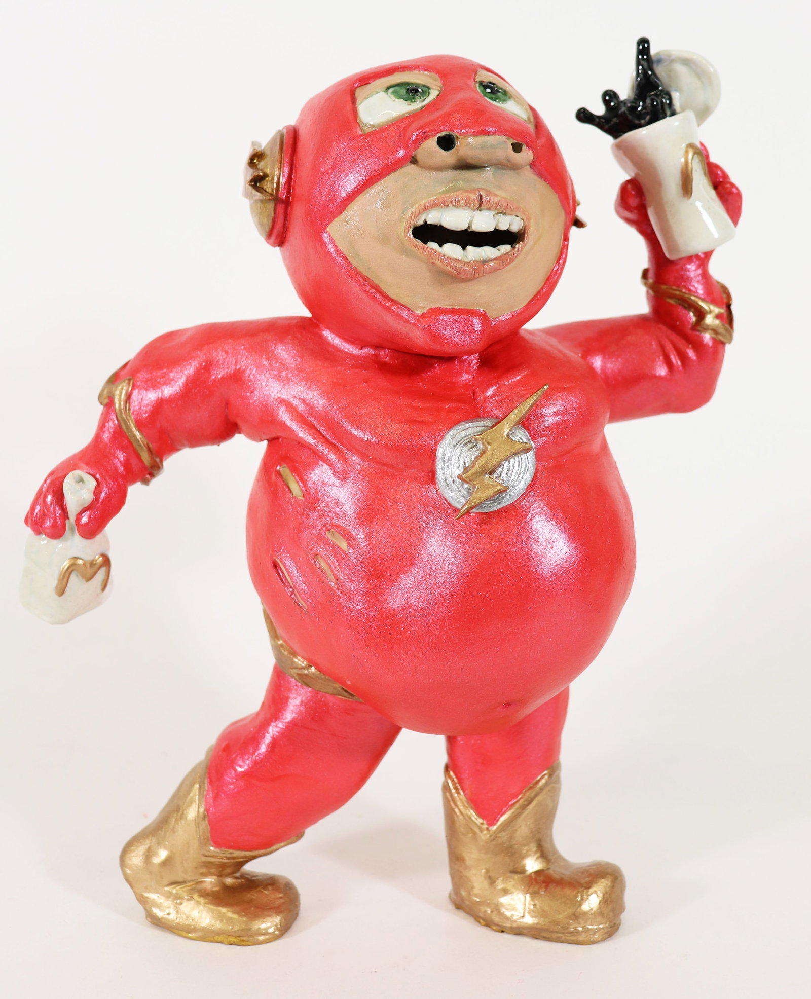 JEREMY WARDELL THE FLASH AT MCDONALDS SCULPTURE: Jeremy Wardell Folk Art pottery sculpture of a whimsical The Flash super hero snacking on McDonalds! Measures 11" tall, 8.5' x 5" wide.